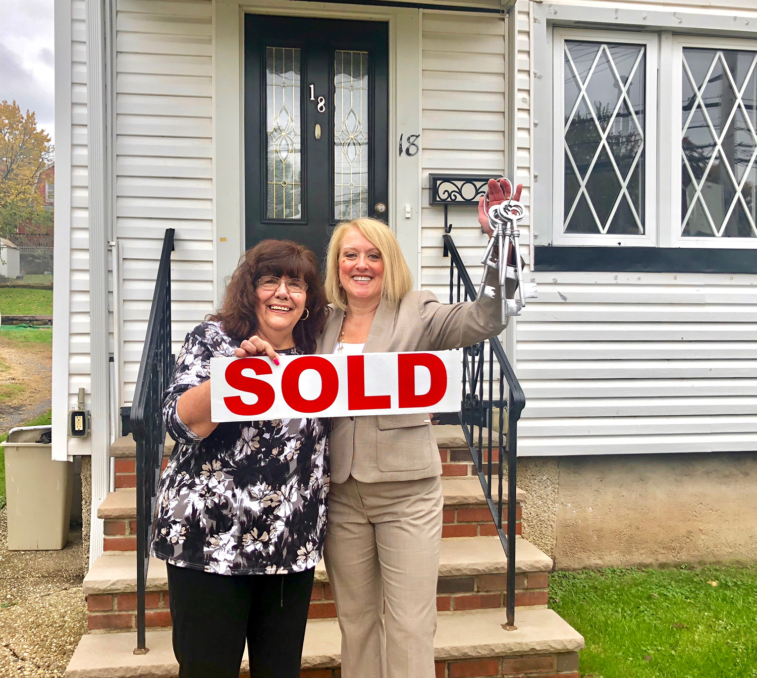 Happy Client Libby in front of her new home with Holly Wiesner Olivieri