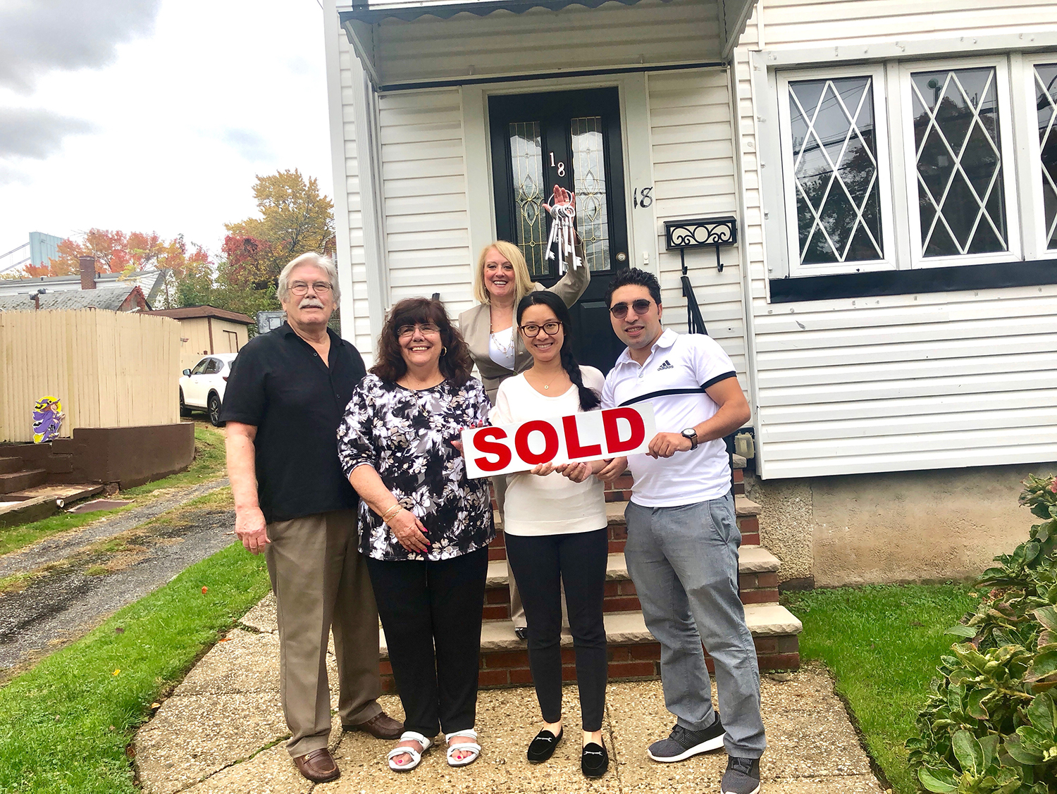 Happy Clients with Holly Wiesner Olivieri in front of their new home