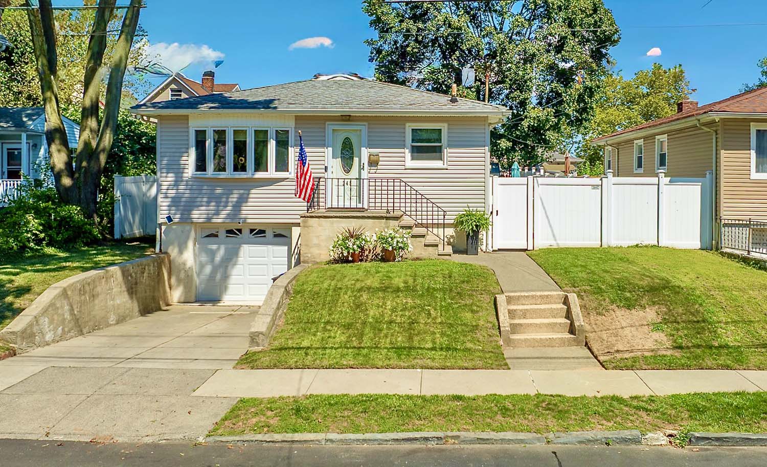 DJI_0748 Front view of a renovated all-brick Cape Cod style home at 553 Oakland Avenue in Sunset Hill, Staten Island. Features new pavers, driveway, and Trex deck.