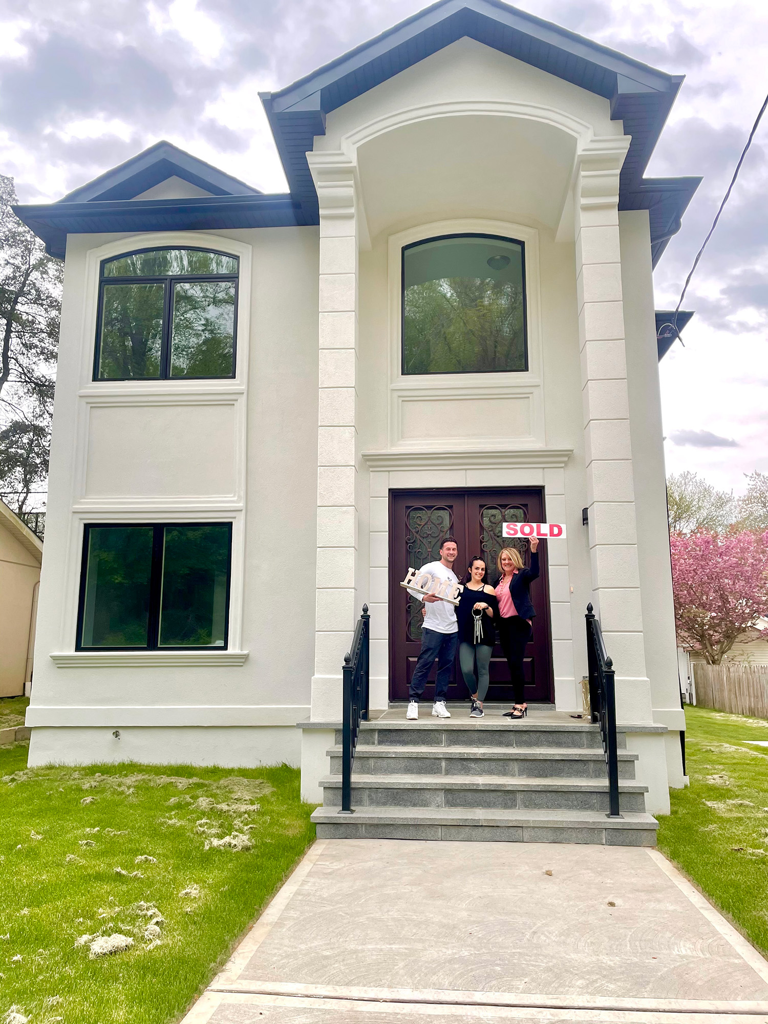 Don and Ariana with Holly in front of their new Richmond Town home in Staten Island